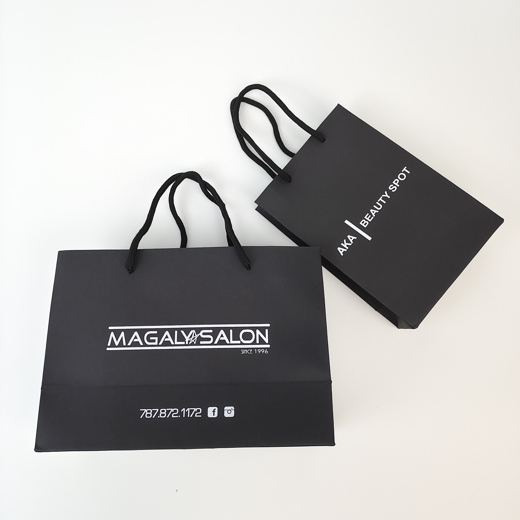 structured black paper shopping bag with silver printed decoration - view 2