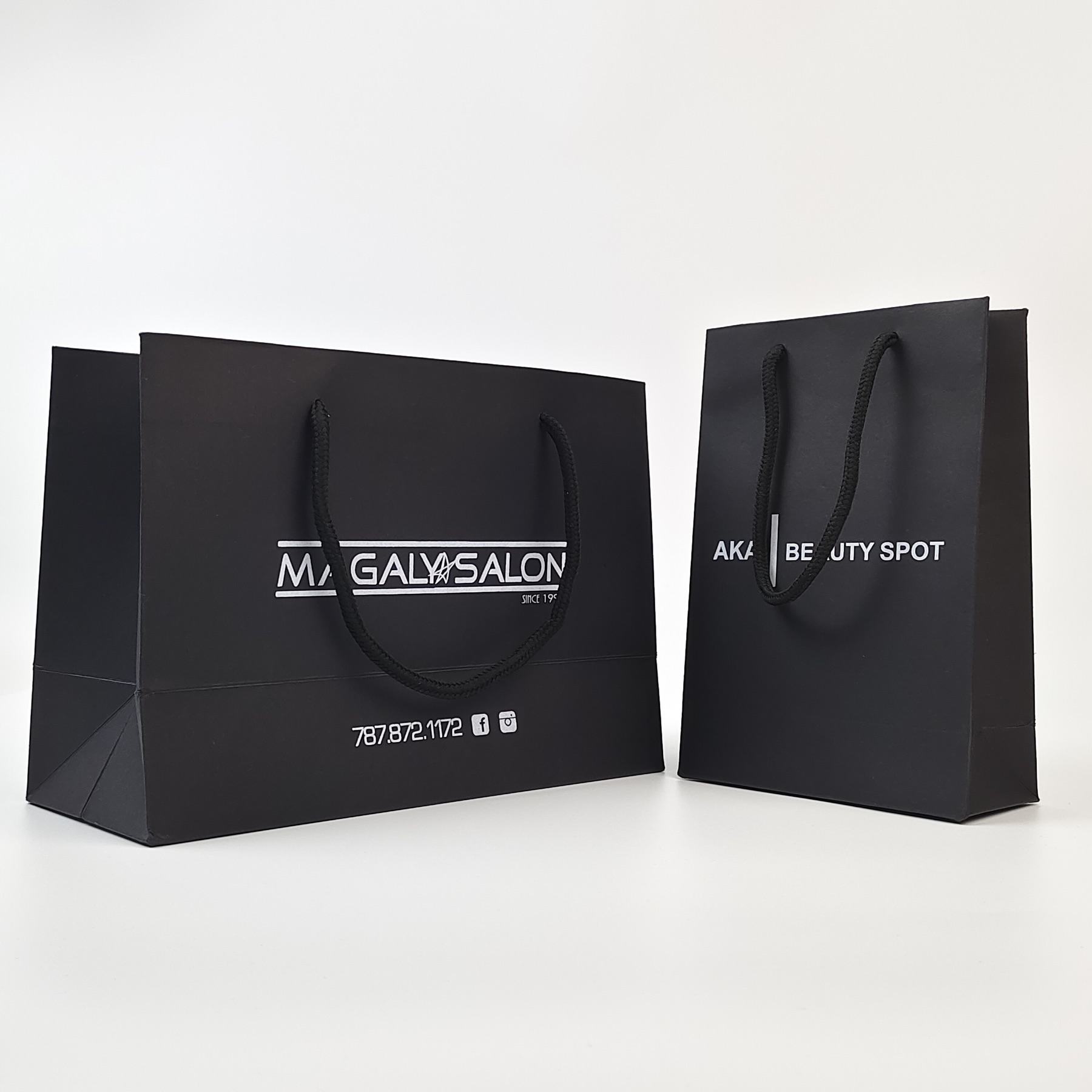 structured black paper shopping bag with silver printed decoration - view 3