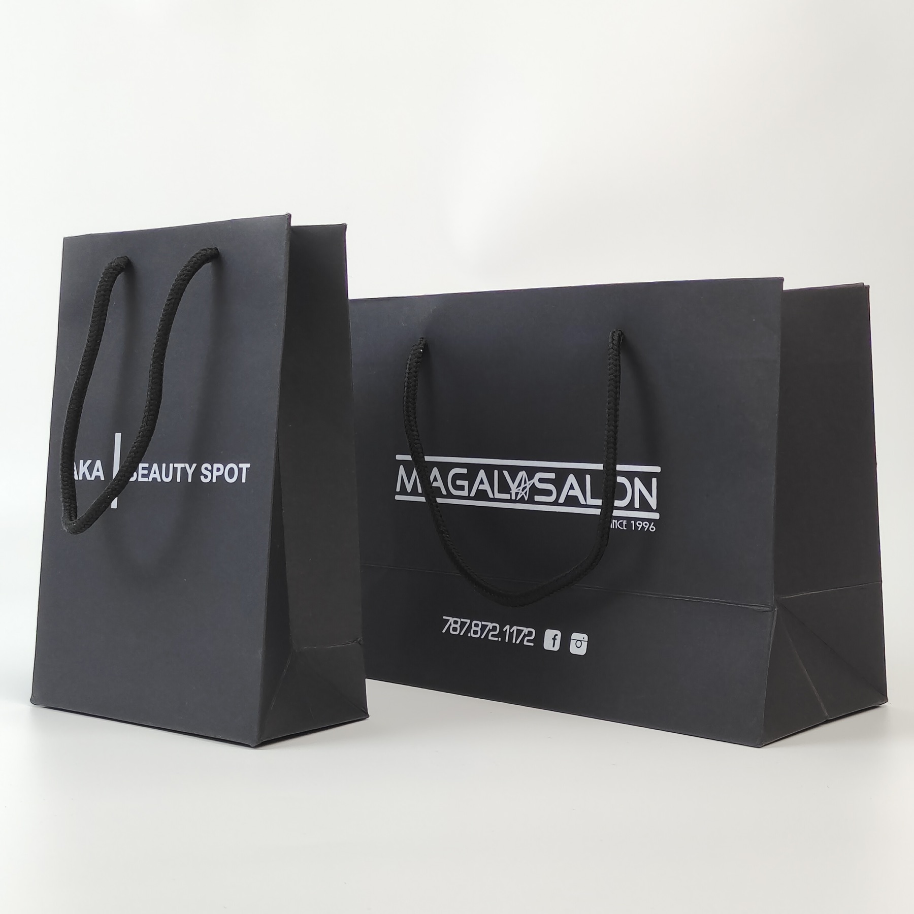 structured black paper shopping bag with silver printed decoration - view 4