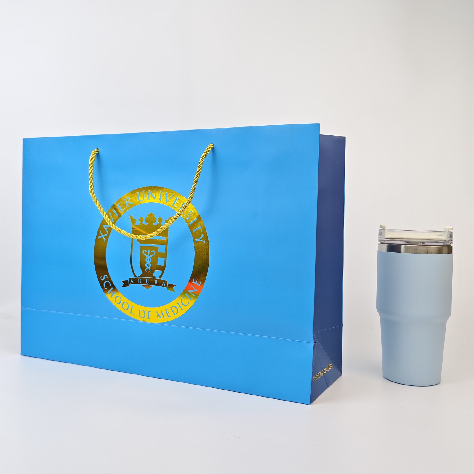 bright blue paper presentation bag with gold foil logo and rope handles - view 3