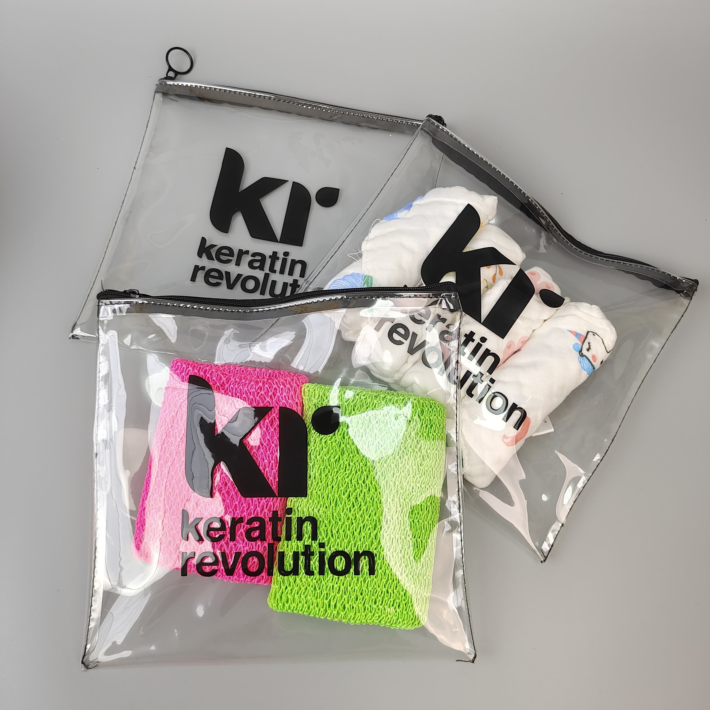 clear printed PVC zipper pouch holding colorful hair care accessories - view 5