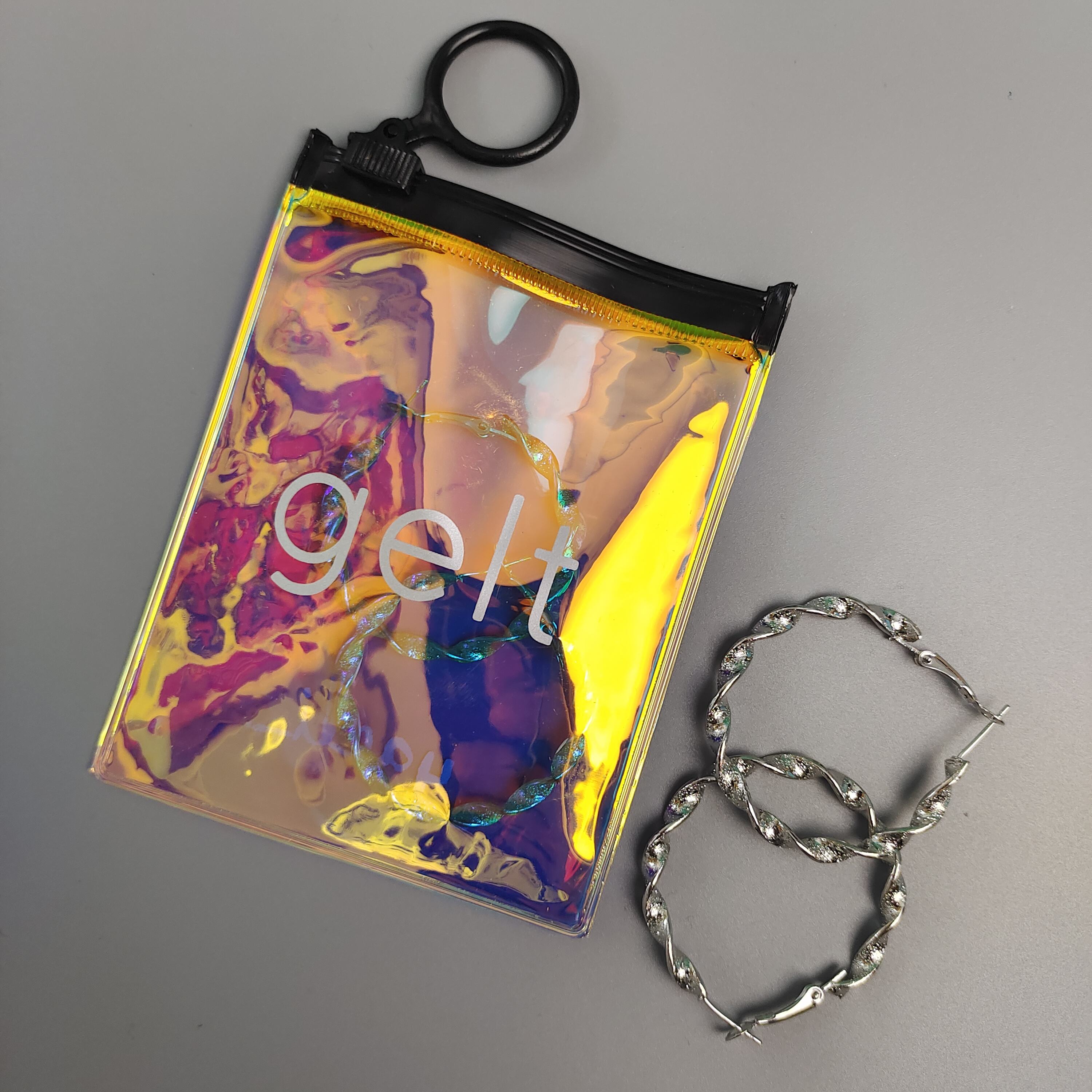 small holographic PVC jewelry pouch with circular black ring pull - view 6