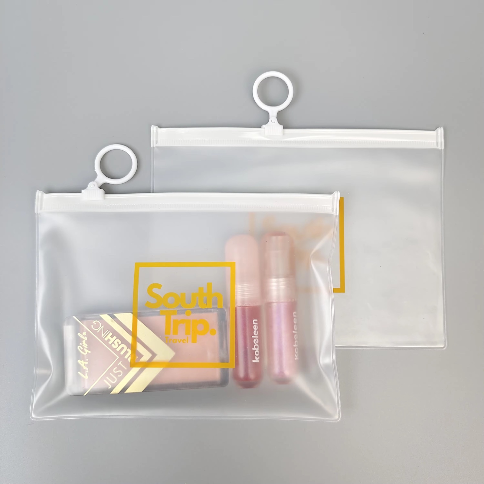 frosted PVC travel pouch with white zipper and circular ring pull - view 2